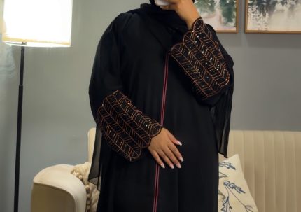 Classic black abaya with a clean, minimal silhouette and delicate handwork on the sleeves, elegant modest wear suitable for everyday sophistication or special gatherings.